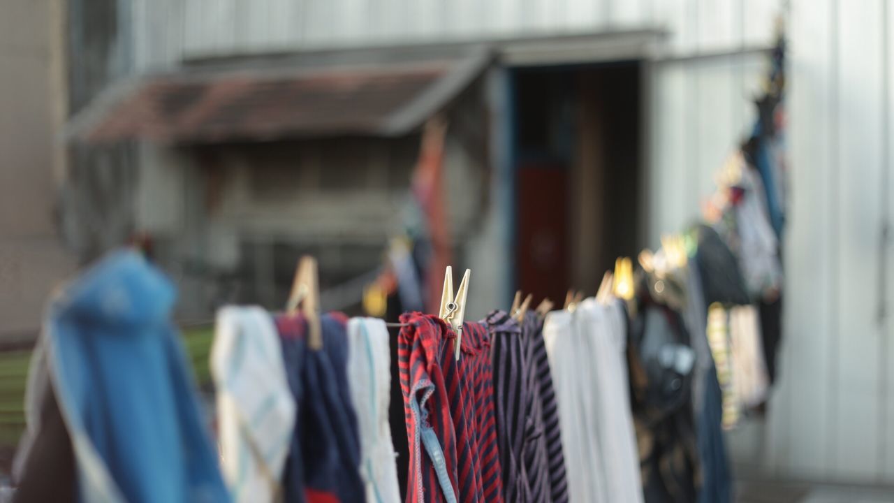 CLOSE-UP OF CLOTHES HANGING OUTDOORS