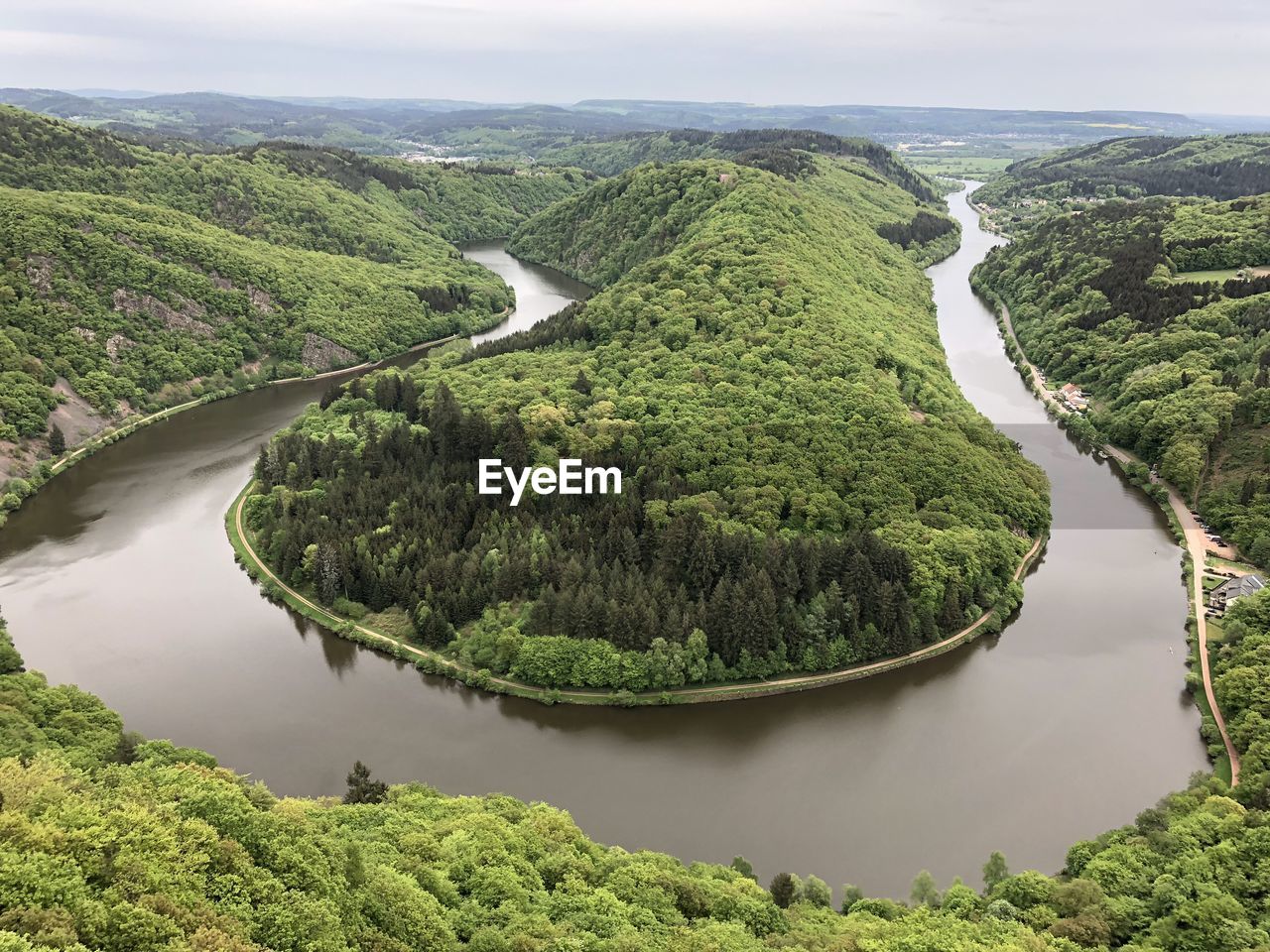 High angle view of river amidst trees against sky