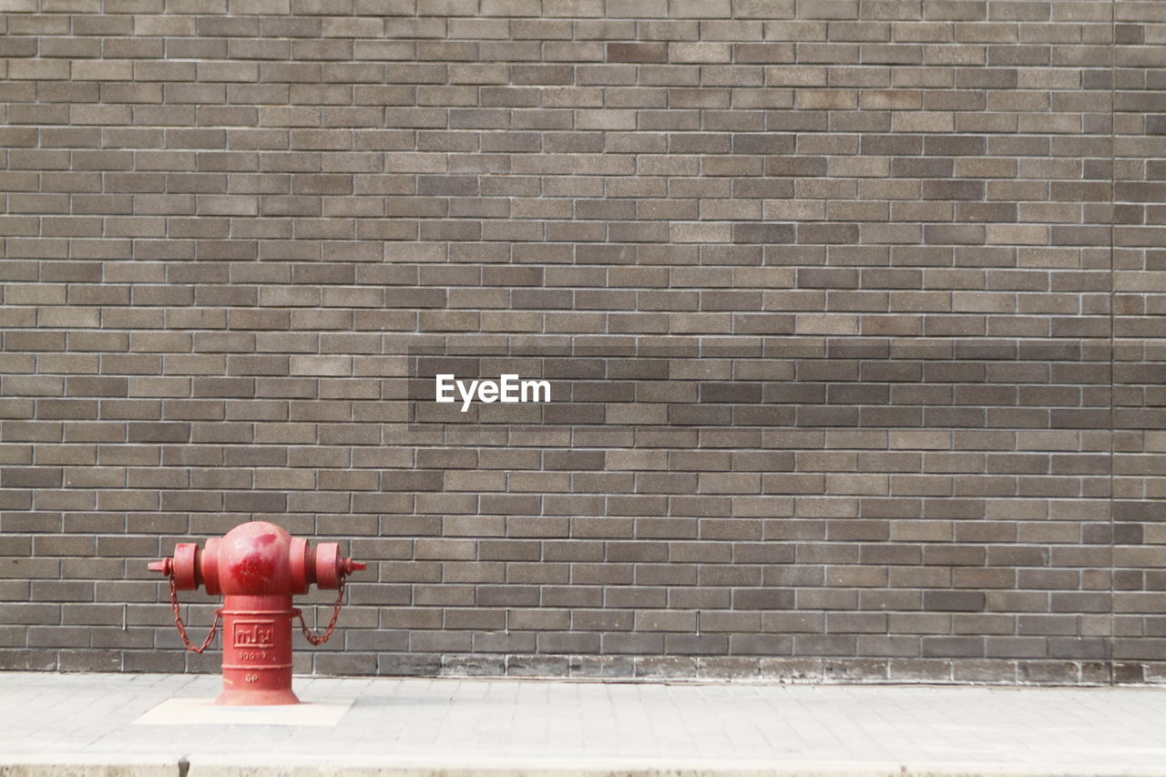 RED FIRE HYDRANT ON WALL