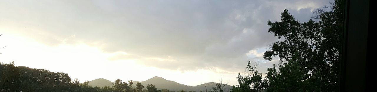 SCENIC VIEW OF MOUNTAINS AGAINST CLOUDY SKY