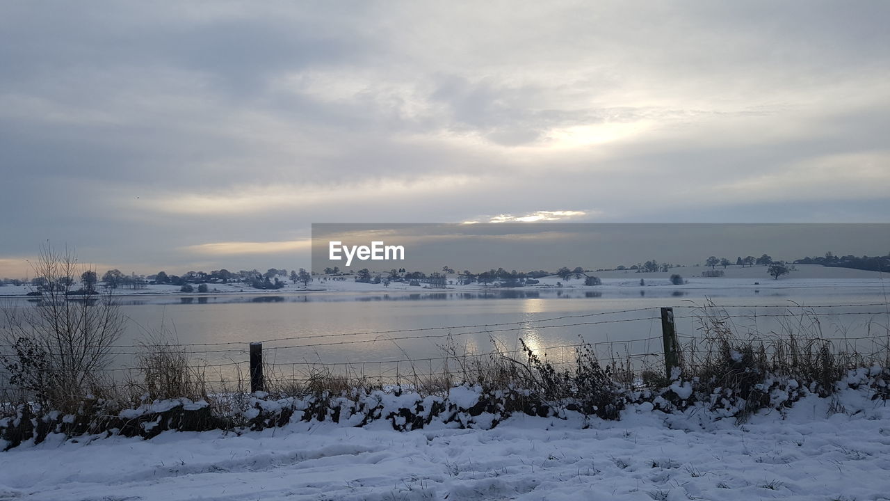 Scenic view of frozen lake against sky during winter