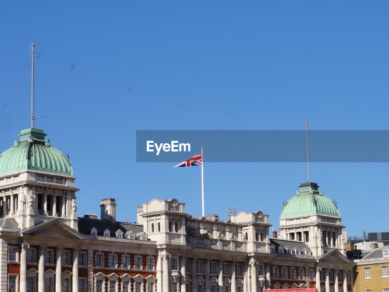 Low angle view of buildings against clear blue sky