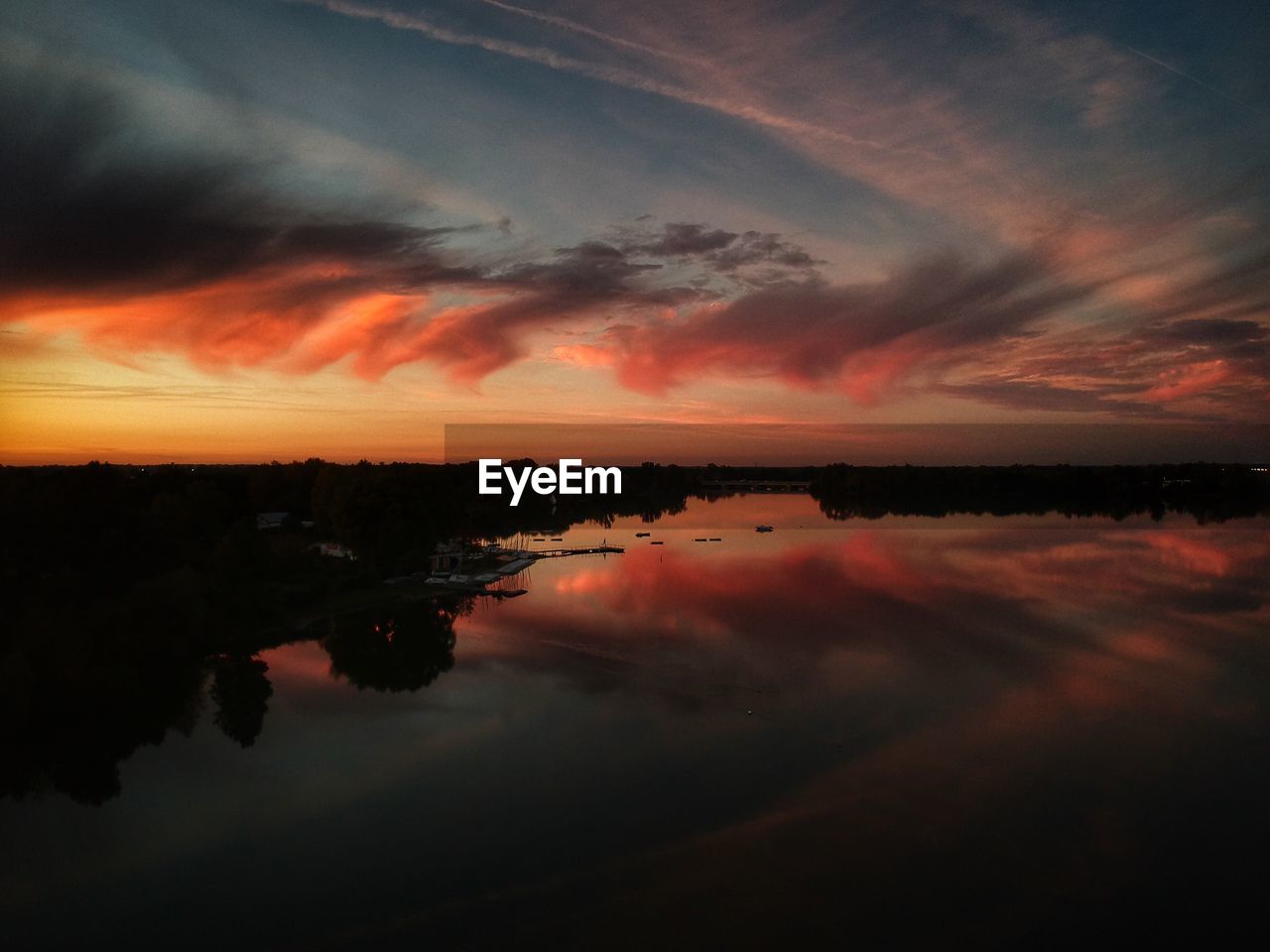 Scenic view of lake against romantic sky at sunset