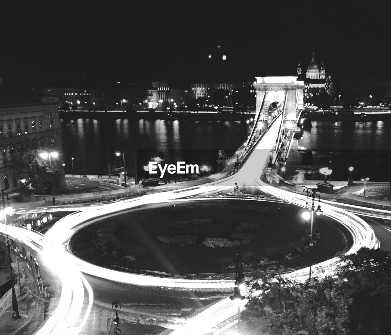 Light trails on road in illuminated city at night