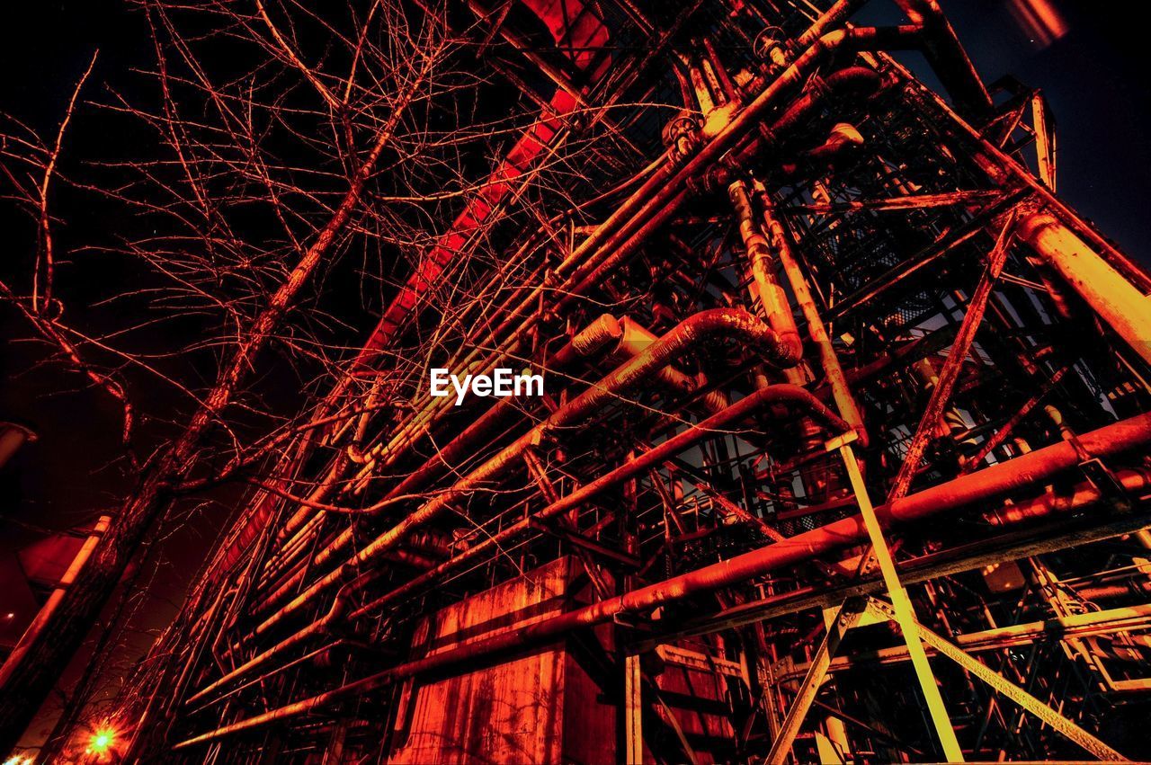 Low angle view of abandoned factory in forest at night