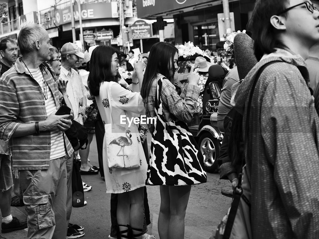 PEOPLE STANDING ON STREET IN CITY