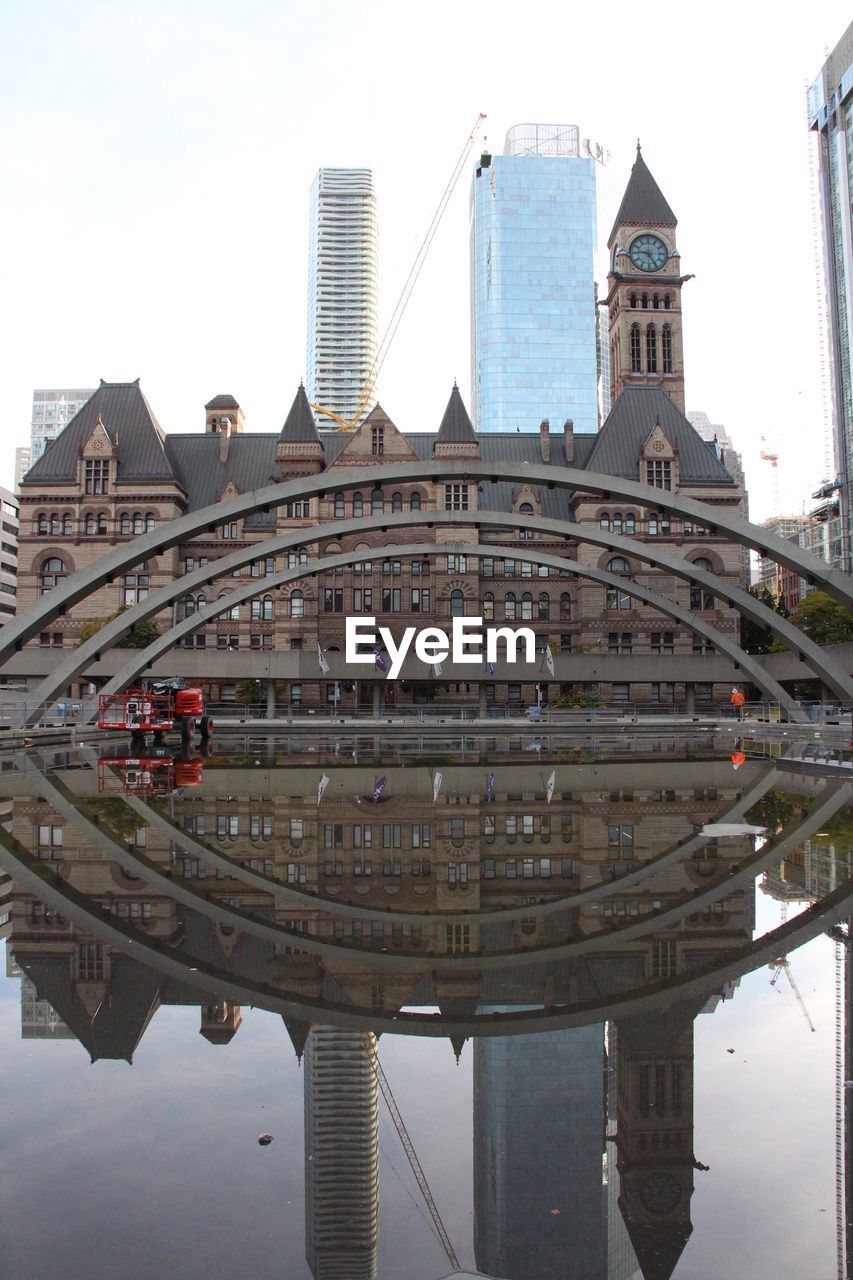 REFLECTION OF MODERN BUILDINGS IN CANAL