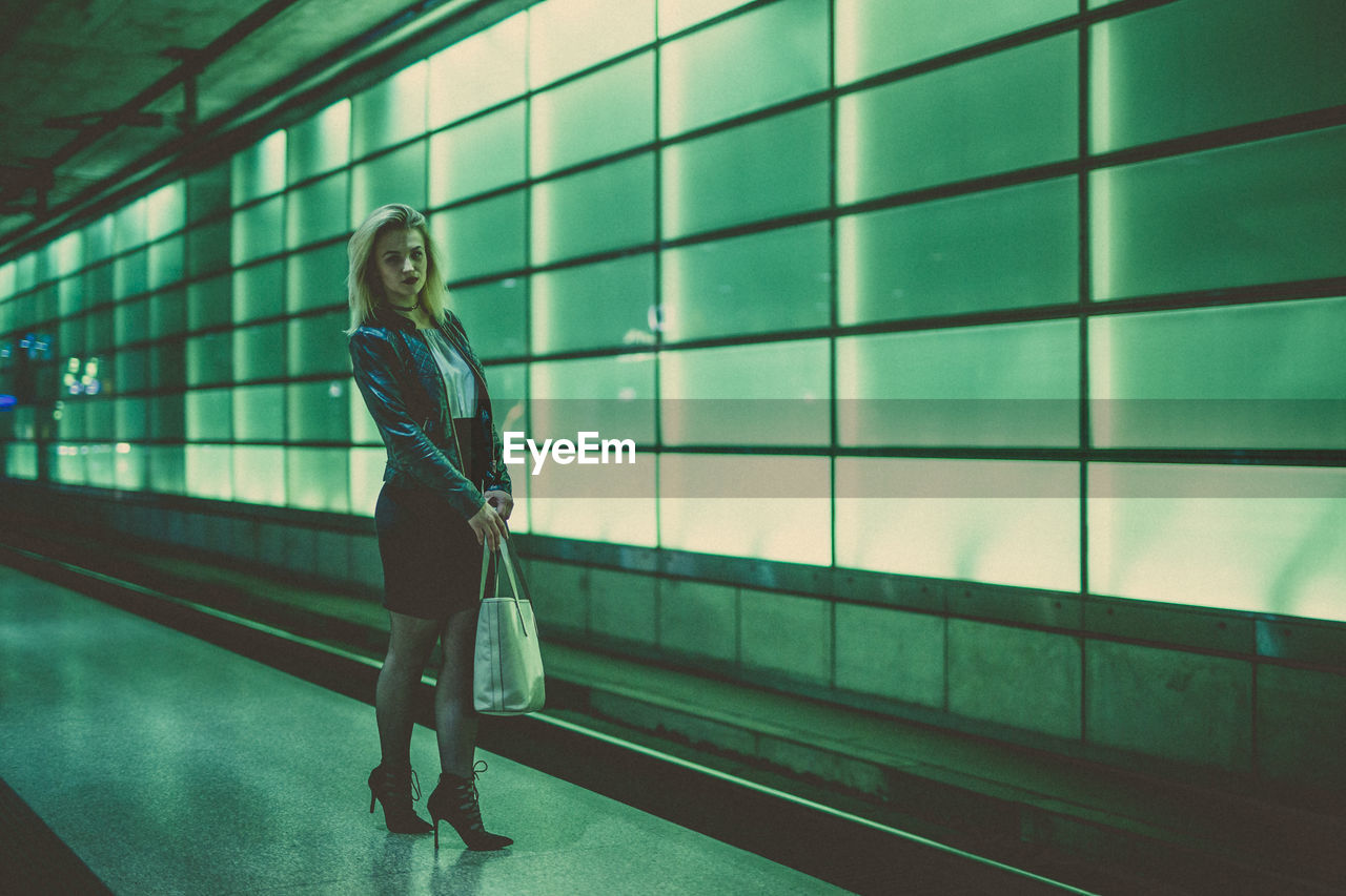 Full length of woman standing at subway station platform