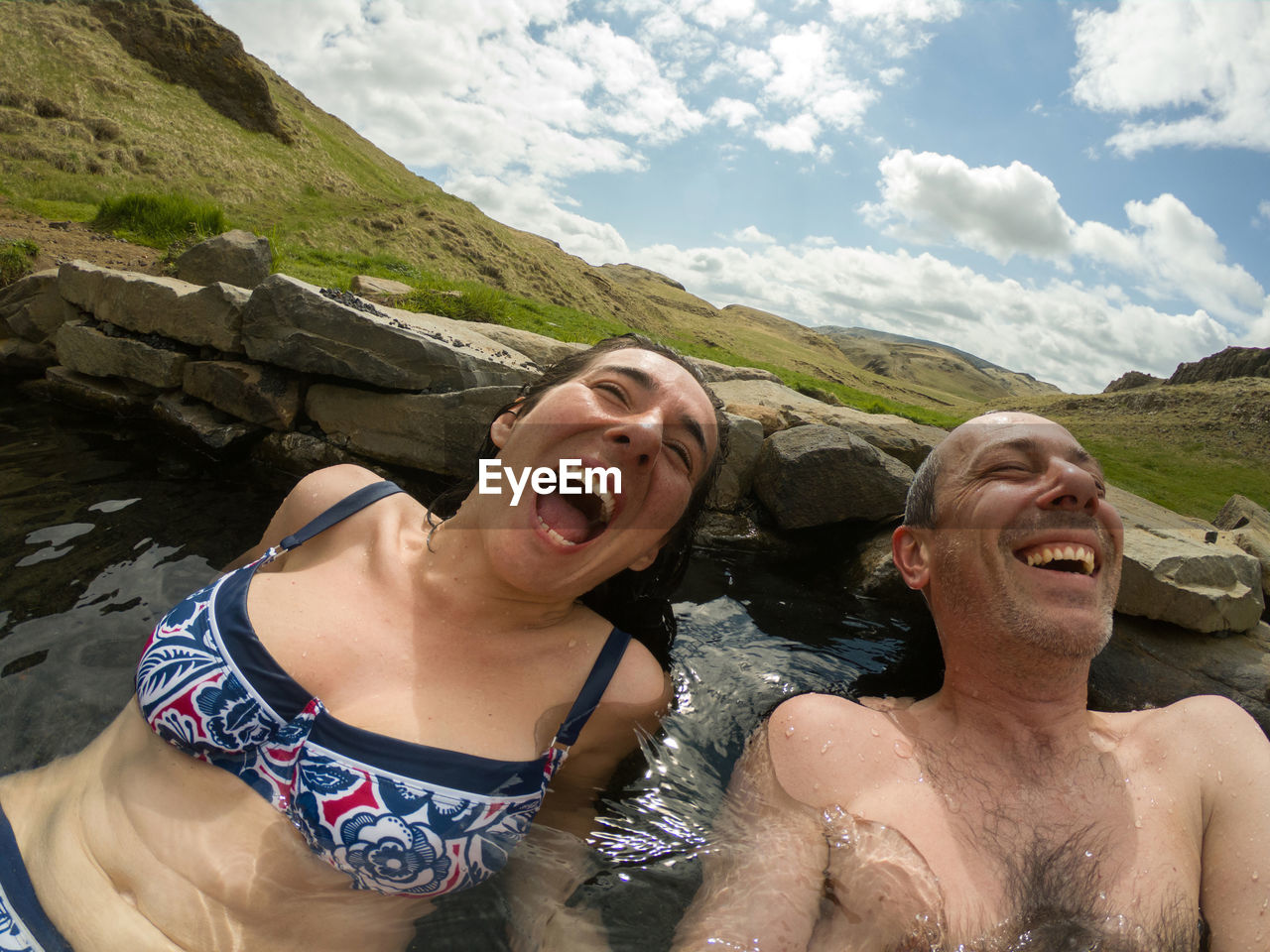 Cheerful people enjoying hot spring