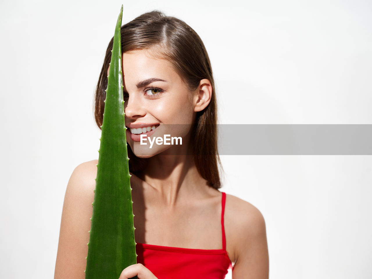 Portrait of beautiful woman smiling against white background