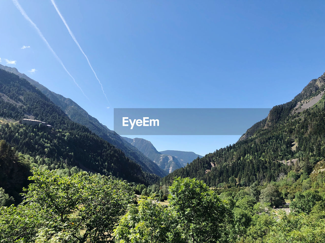 Scenic view of mountains against blue sky