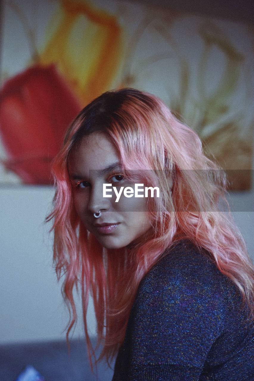 Close-up portrait of young woman with dyed hair