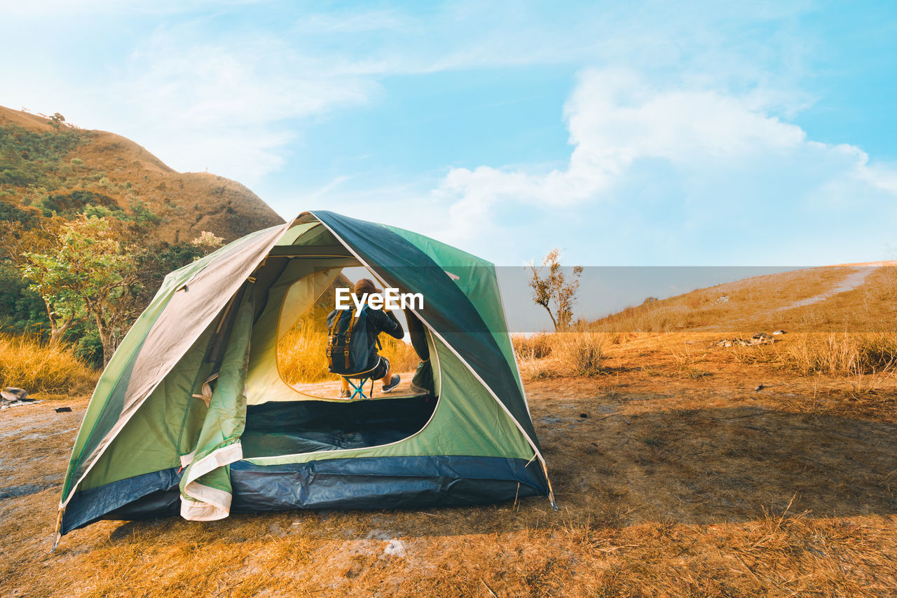 Scenic view of tent on field against sky