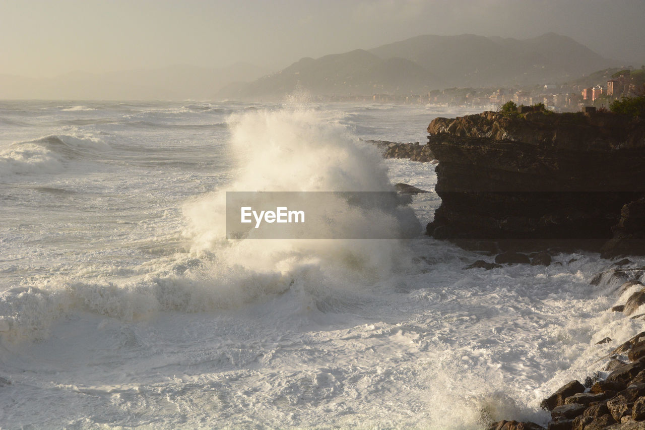 sea, motion, water, wave, shore, coast, ocean, wind wave, beauty in nature, land, body of water, water sports, sports, beach, rock, power in nature, surfing, breaking, scenics - nature, nature, sky, splashing, hitting, environment, outdoors, sand, terrain, cliff, rough