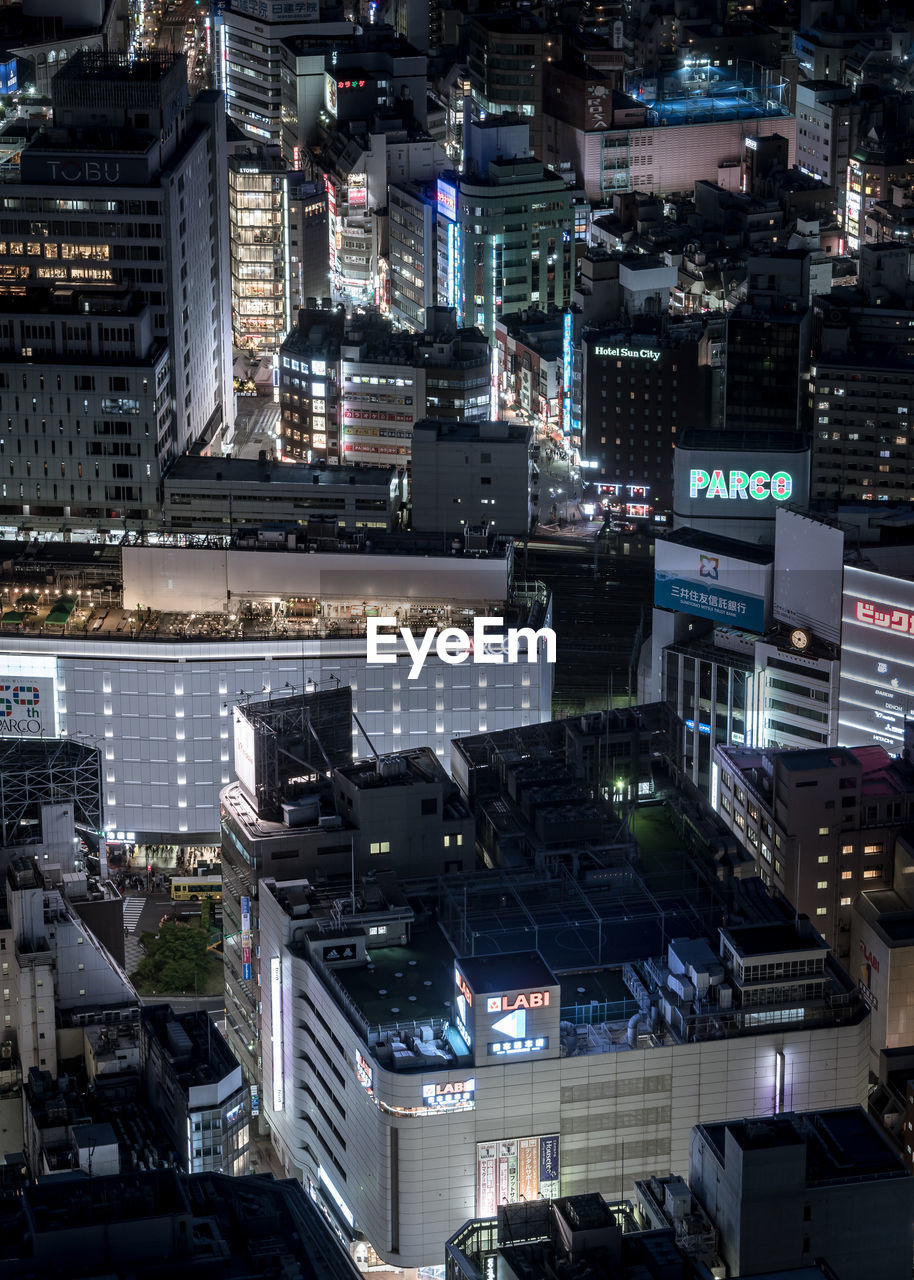 HIGH ANGLE VIEW OF ILLUMINATED CITY BUILDINGS