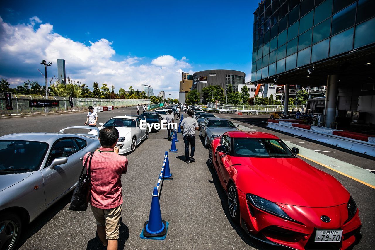 PANORAMIC VIEW OF VEHICLES ON ROAD AGAINST SKY