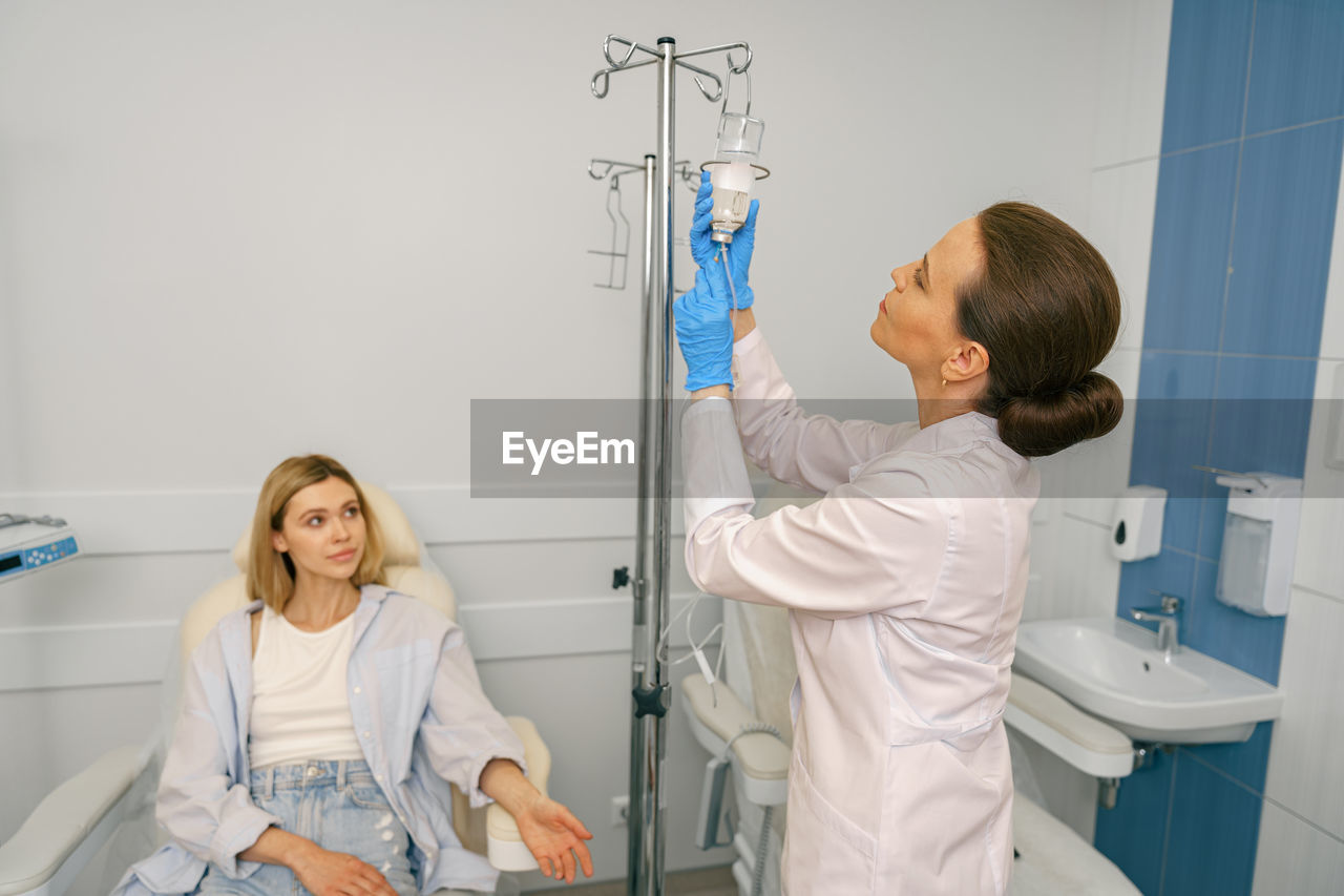 portrait of female doctor examining chemical at clinic