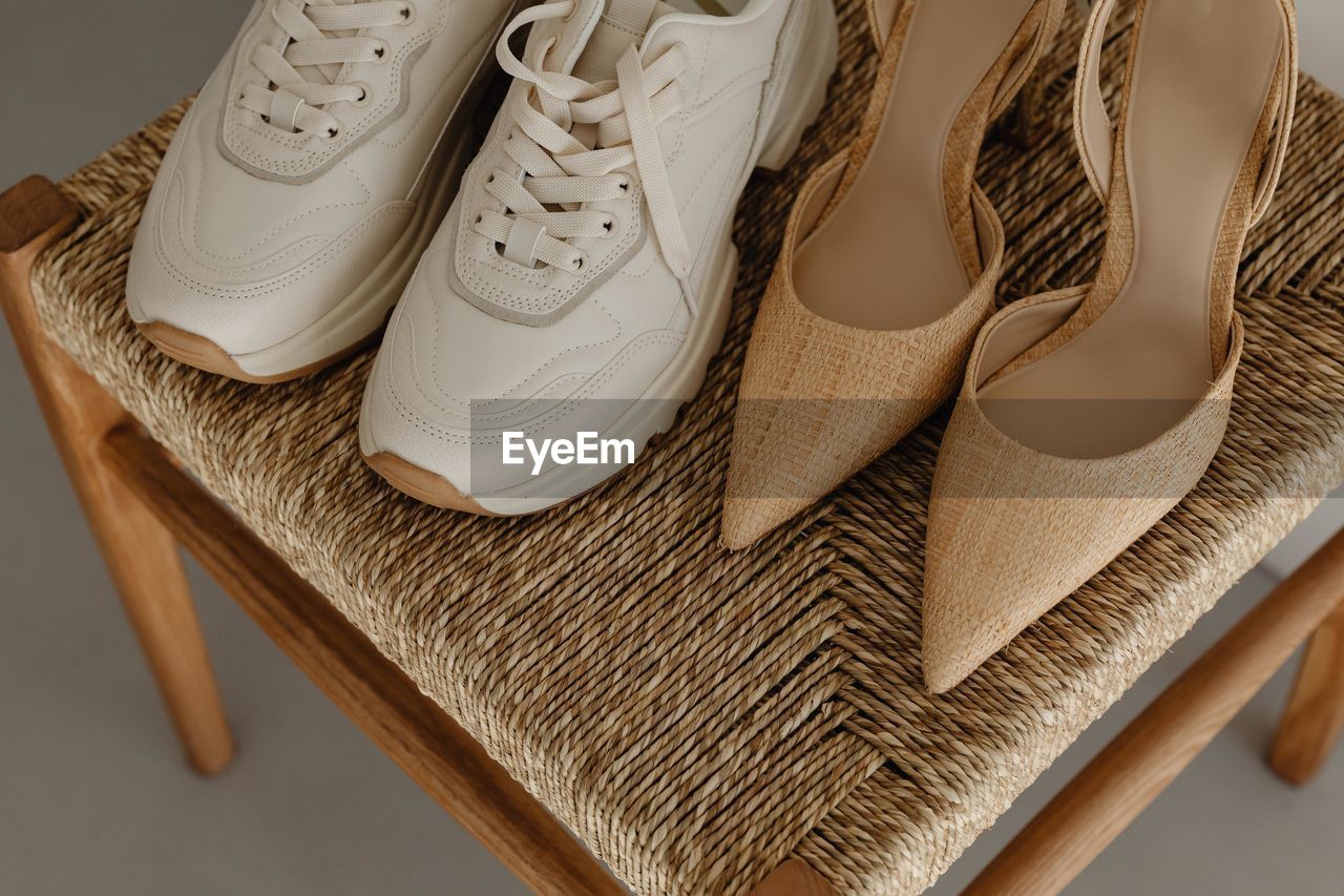 footwear, shoe, brown, fashion, indoors, no people, clothing, pair, studio shot, elegance, white, retail, close-up, still life, high heels, group of objects, wood, outdoor shoe, shopping