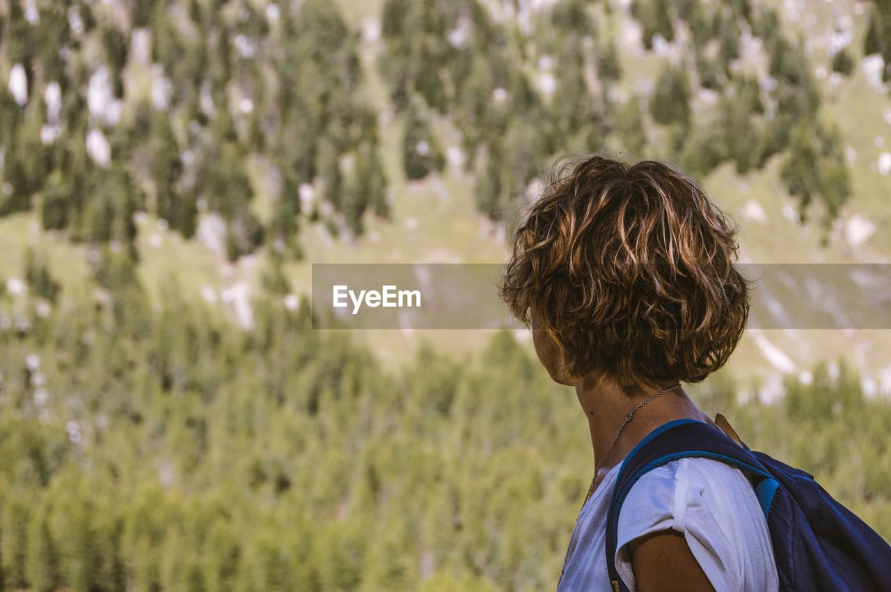 Side view of woman looking at mountain