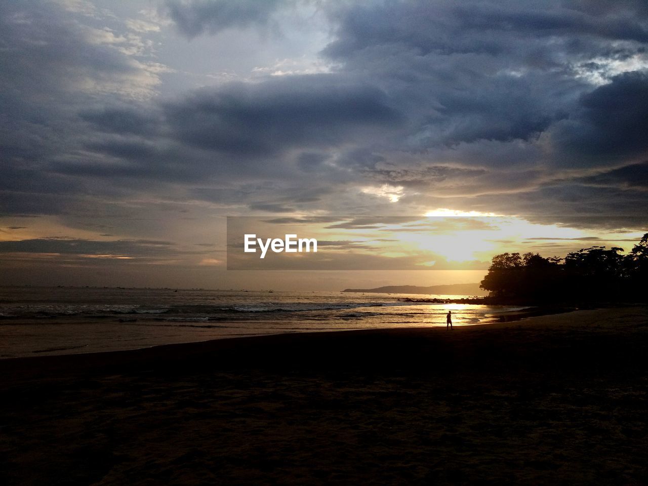 SCENIC VIEW OF BEACH DURING SUNSET