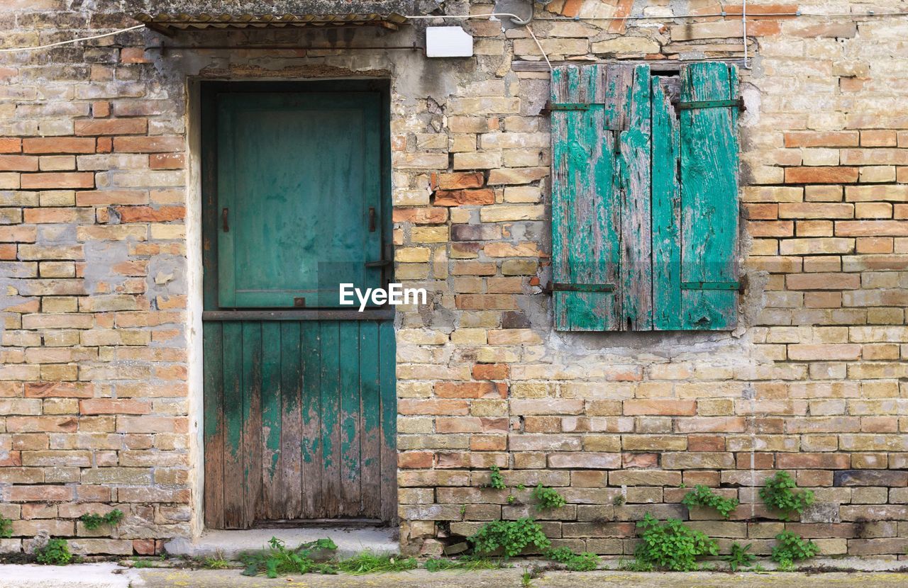 CLOSED DOOR OF STONE WALL