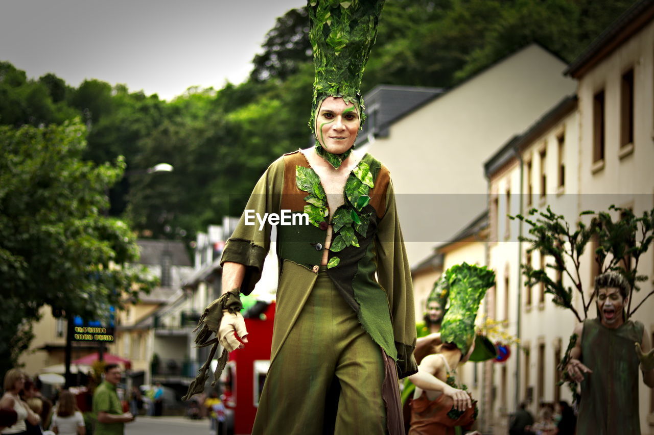 FULL LENGTH OF MAN STANDING BY PLANTS