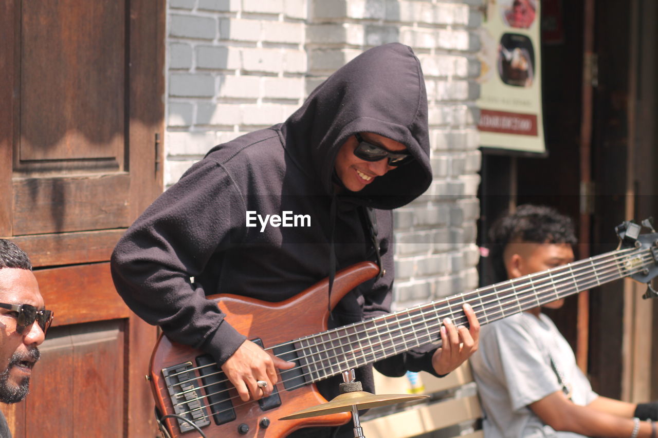 Man playing guitar at  side walk music concert