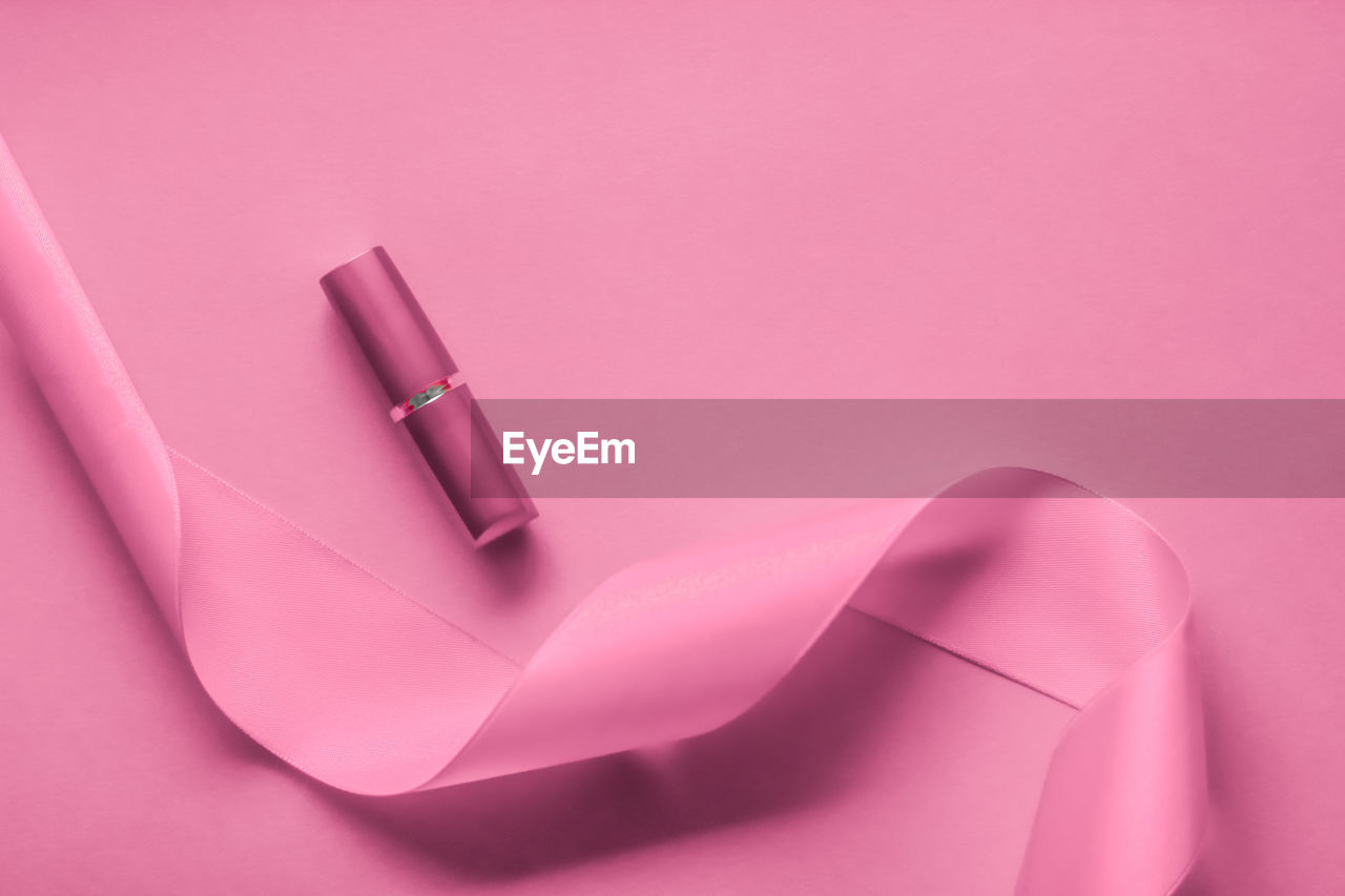 high angle view of paper on pink background