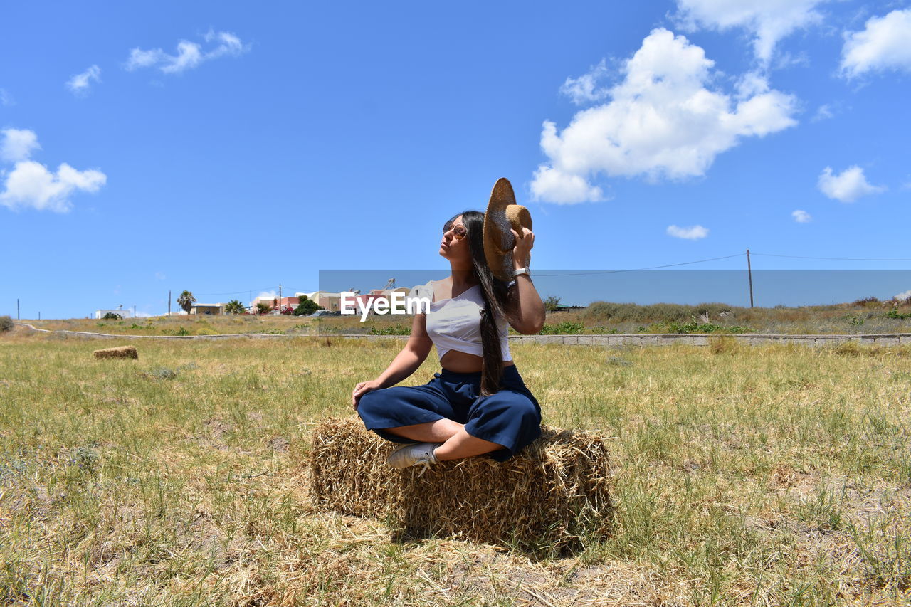 Woman sitting on field