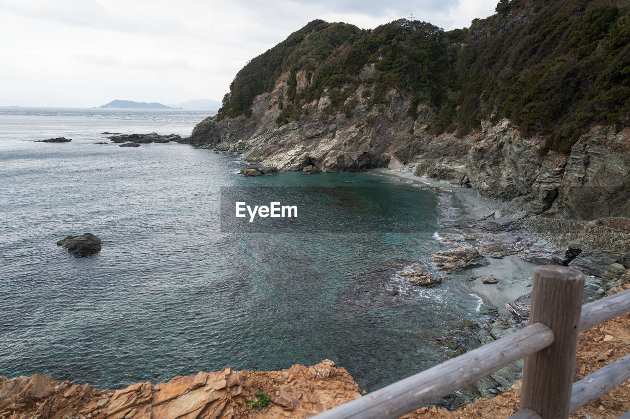 water, sea, land, beach, coast, scenics - nature, shore, body of water, beauty in nature, sky, rock, nature, coastline, environment, cliff, landscape, travel destinations, cove, tranquility, cloud, bay, travel, ocean, mountain, tranquil scene, no people, tourism, non-urban scene, outdoors, day, bay of water, terrain, island, idyllic, holiday, trip, vacation, rock formation, seascape, sand, coastal feature, rocky coastline
