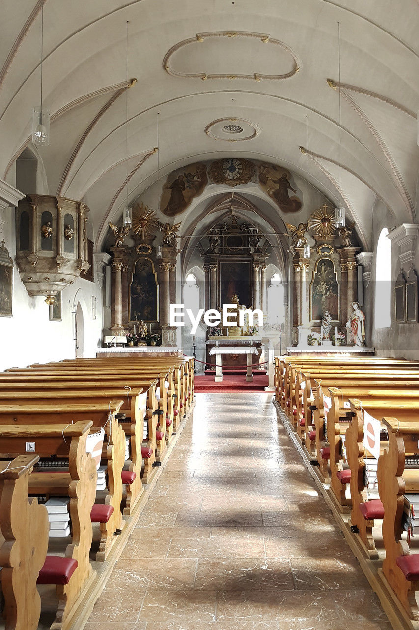 aisle, architecture, religion, belief, arch, spirituality, pew, place of worship, indoors, built structure, building, catholicism, seat, bench, in a row, altar, no people, travel destinations