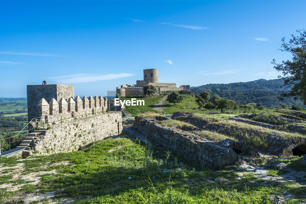low angle view of old ruins against clear blue sky