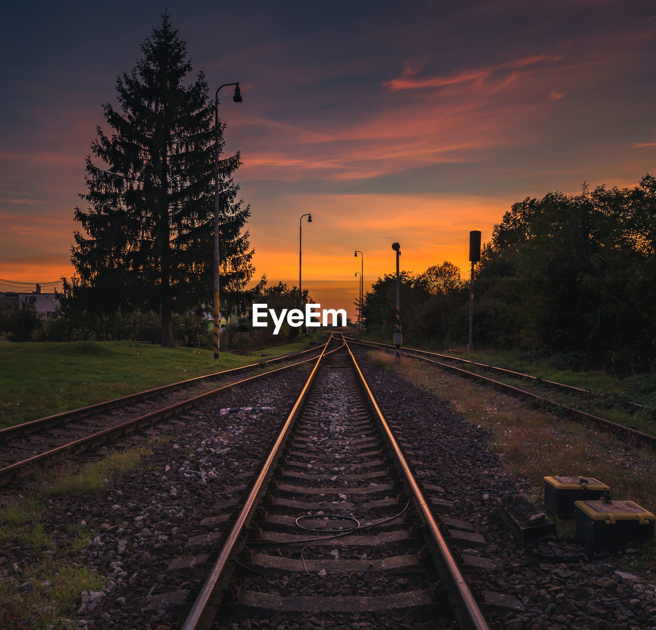 Railroad tracks against sky during sunset