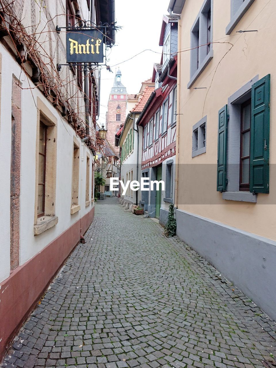 COBBLESTONE STREET AMIDST BUILDINGS