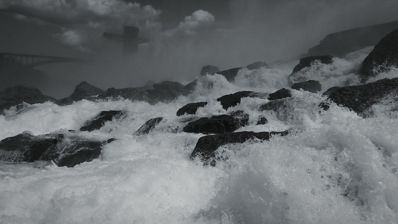 WAVES SPLASHING ON ROCKS AT SEA