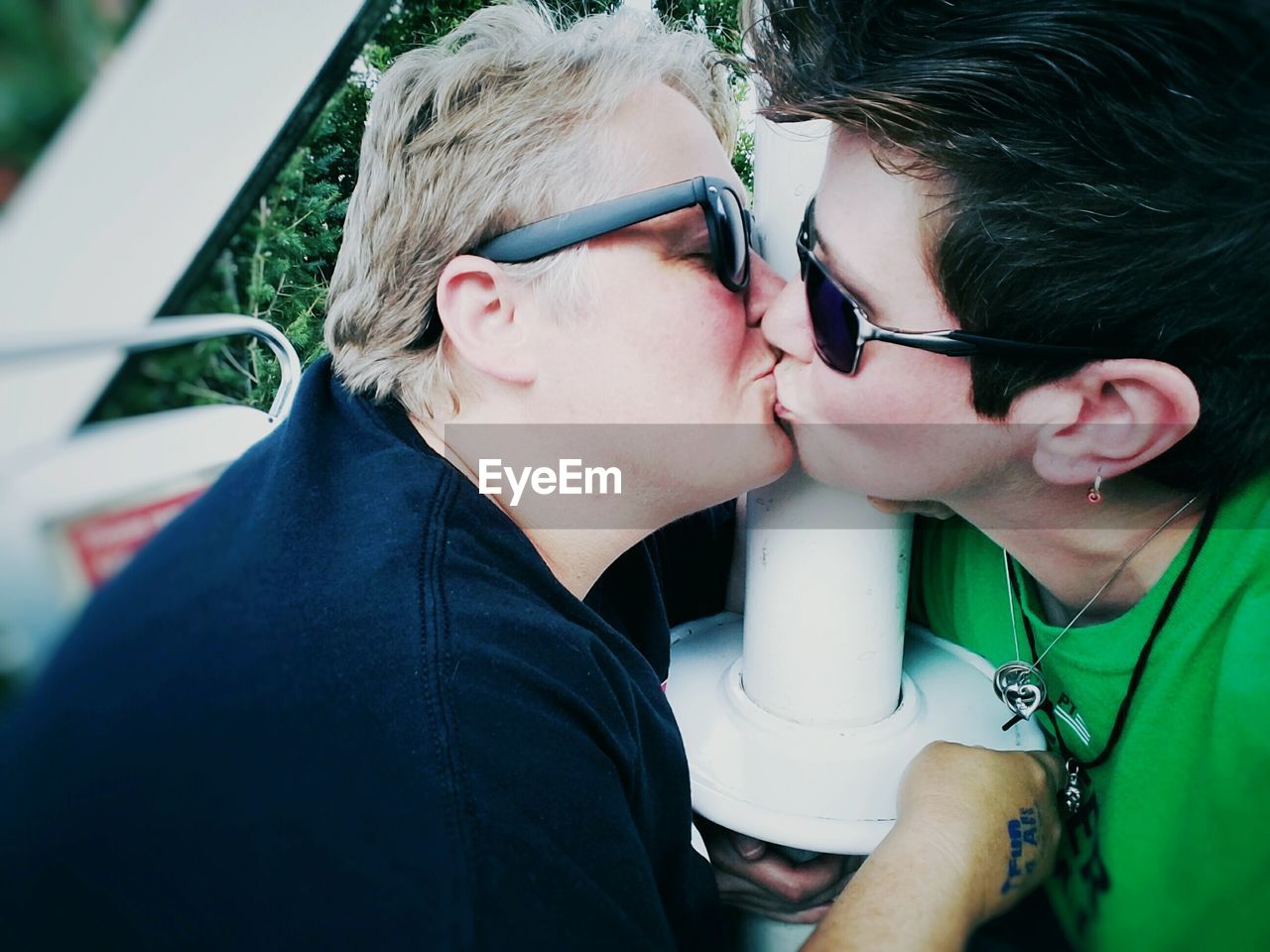 Lesbian couple kissing on ferris wheel