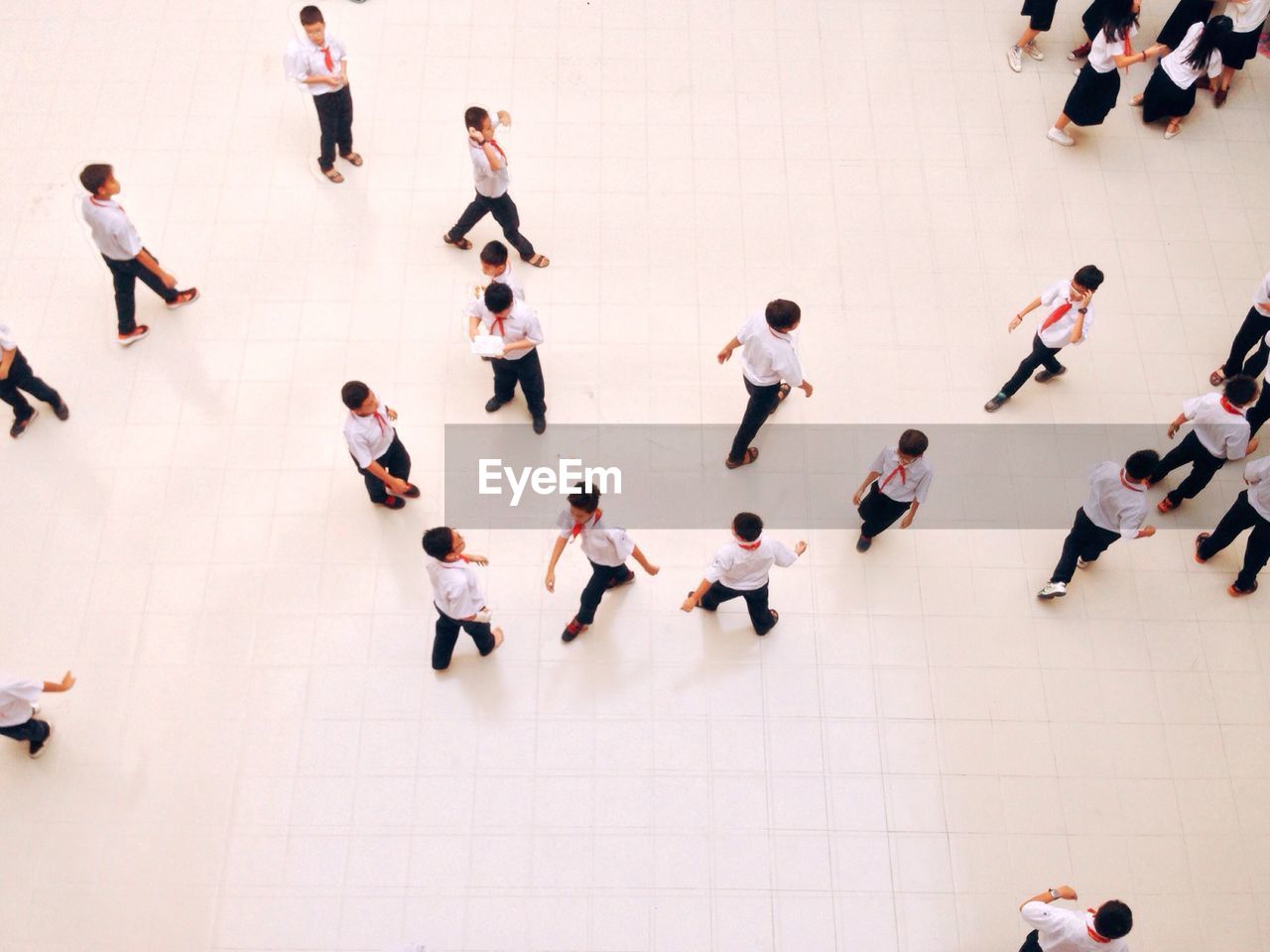 High angle view of students playing on tiled floor