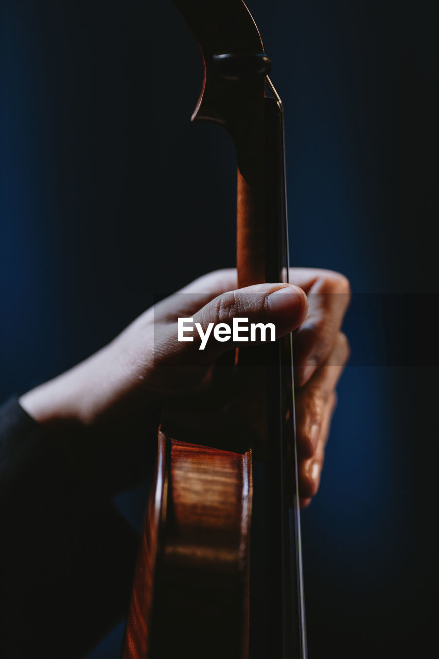 Close up hand holding violin