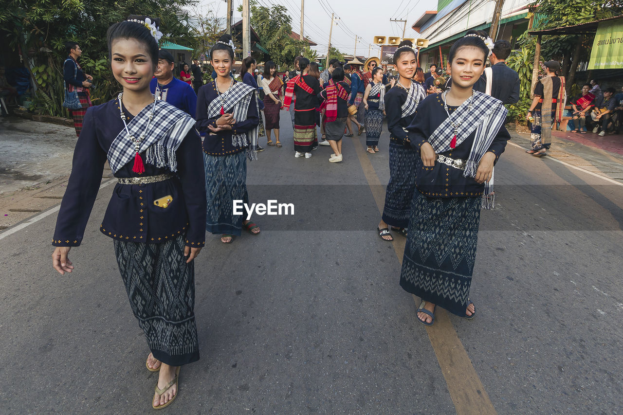 PORTRAIT OF PEOPLE STANDING ON ROAD