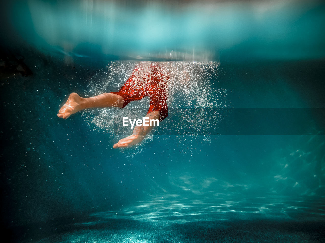 Underwater picture of a boy swimming in a pool