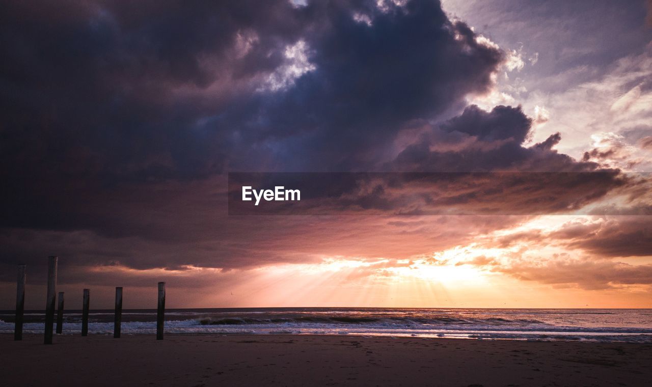 Scenic view of beach against sky during sunset