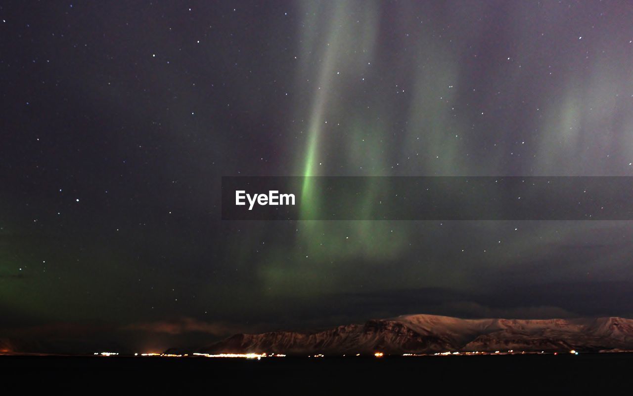 Scenic view of mountain range against sky at night