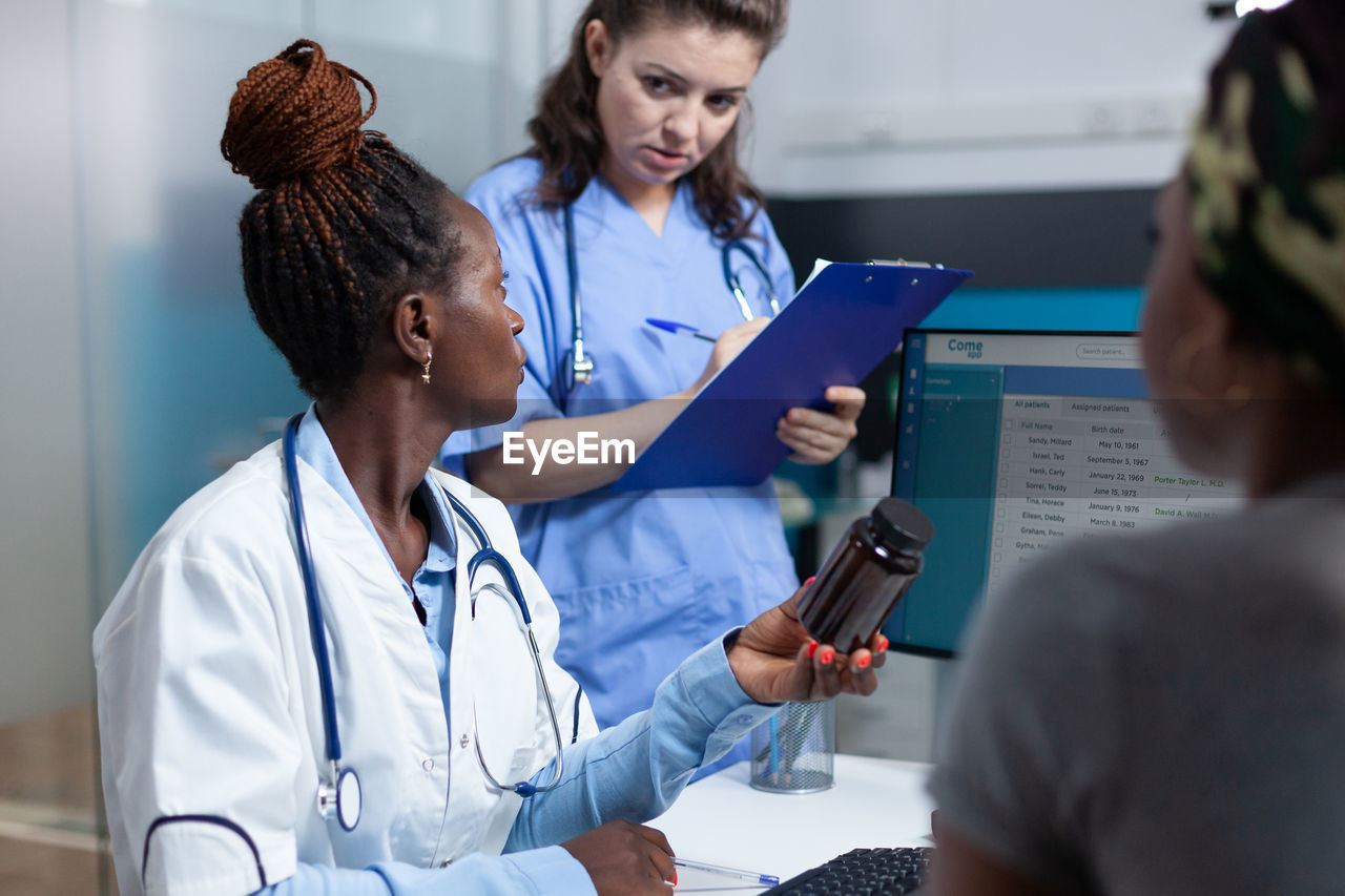 side view of doctor examining patient in meeting at clinic