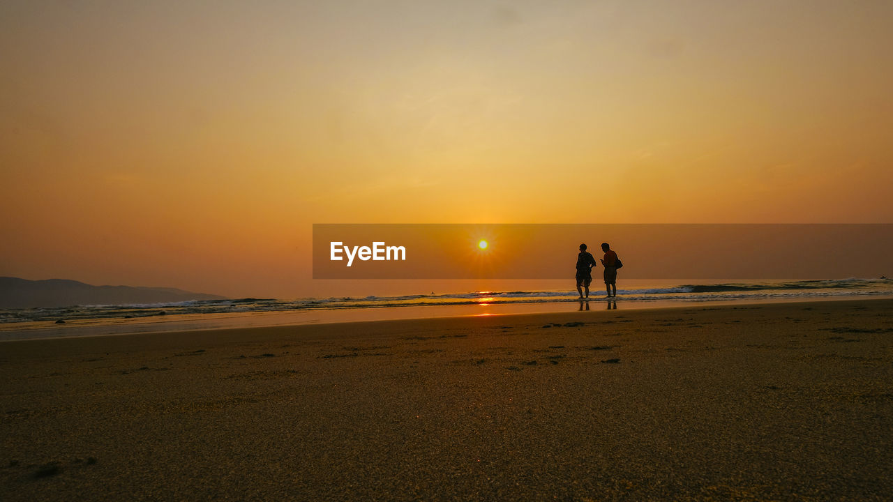 Scenic view of beach against sky during sunset