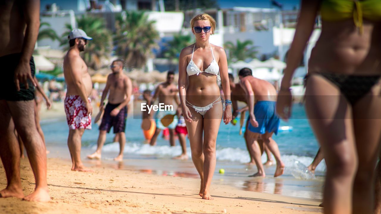Full length of woman in bikini walking at naxos beach