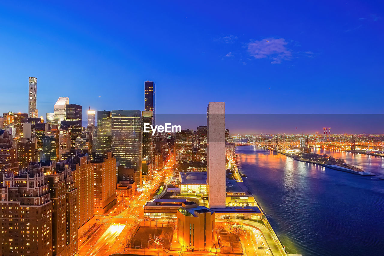 high angle view of illuminated cityscape against sky at night