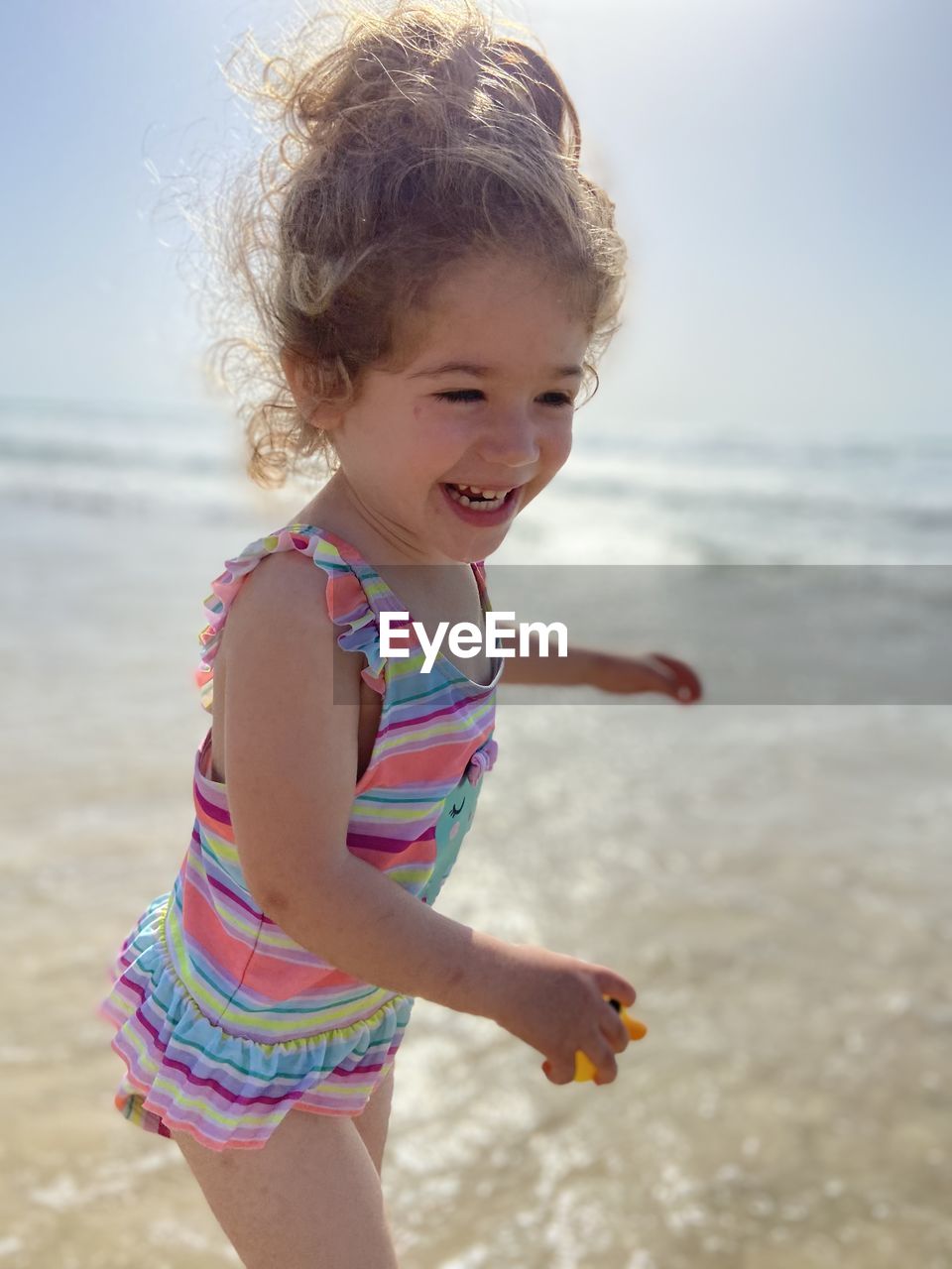 PORTRAIT OF CUTE GIRL ON BEACH