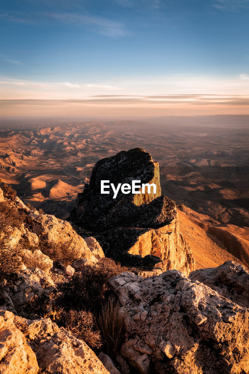 Scenic view of rock formation against sky during sunset