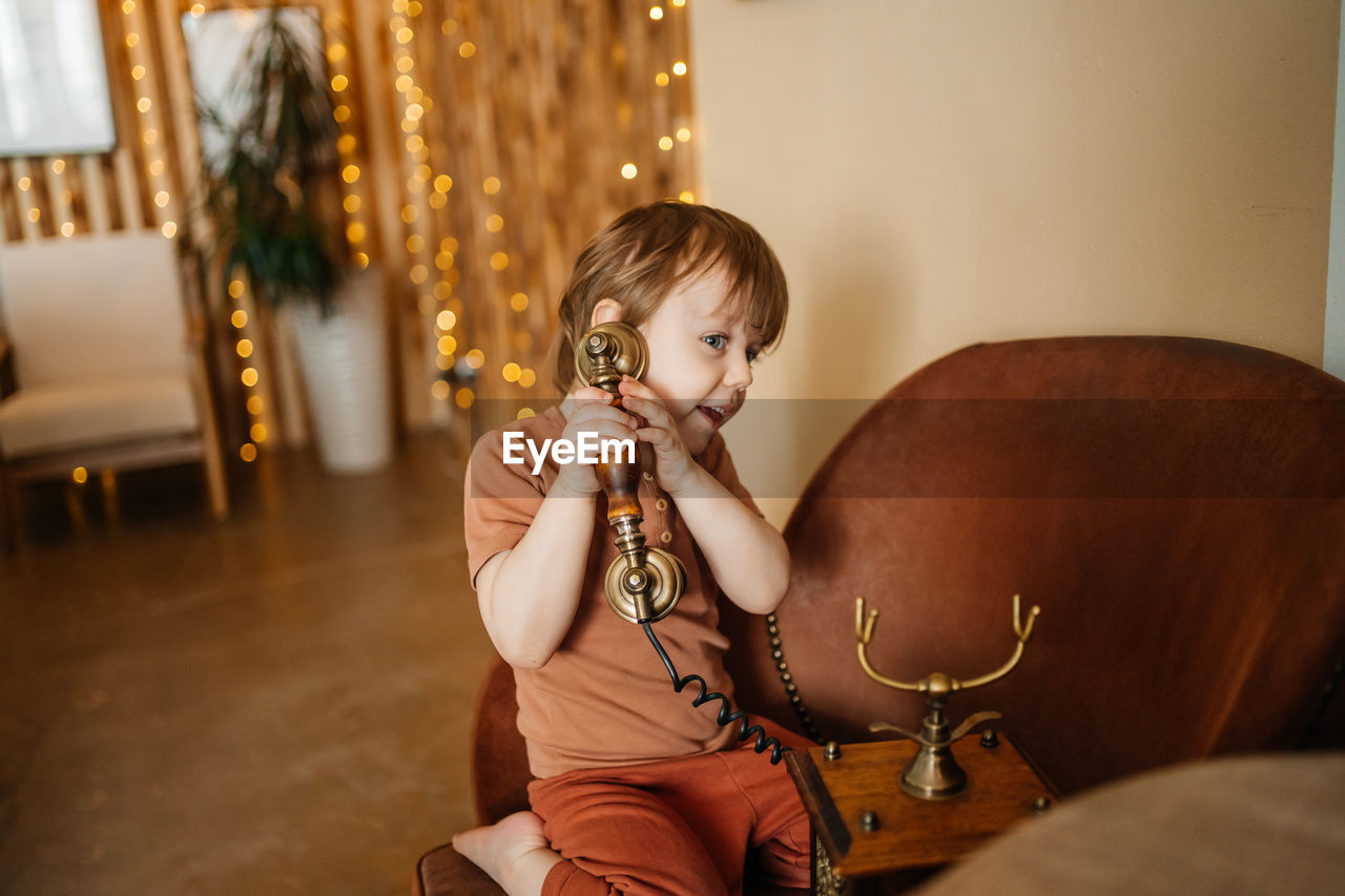 Little boy with antique phone. high quality photo