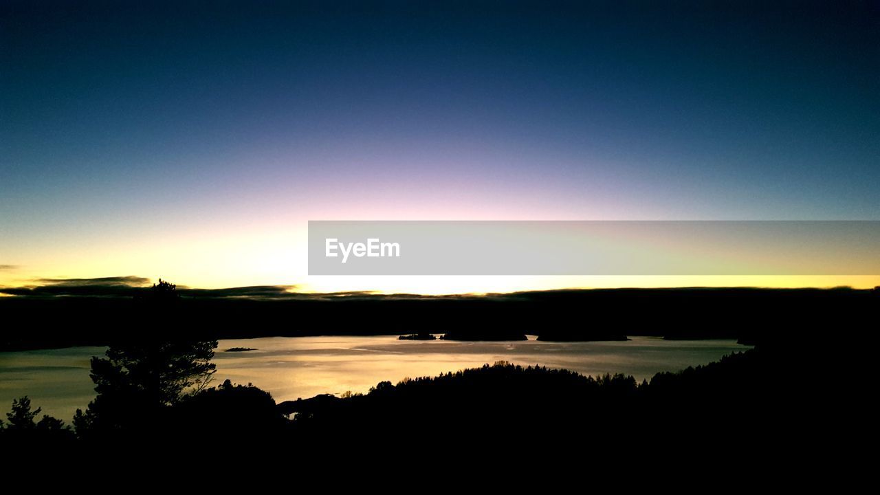 SCENIC VIEW OF LAKE AGAINST ROMANTIC SKY